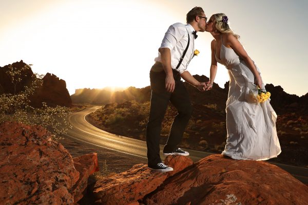 A couple smooching on a rock during their Valley of Fire elopement.