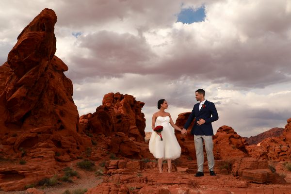 A couple elegantly poses amidst the stunning red rocks of a Valley of Fire wedding.