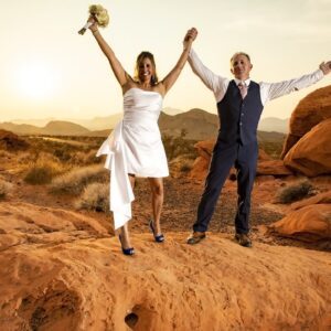 A couple exchanging vows on a rock in the Valley of Fire for their romantic elopement.