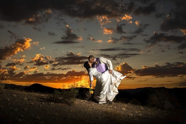 A couple embraces in the Valley of Fire during their sunset wedding.