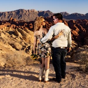A couple stands before a mesmerizing rock formation in the Valley of Fire during their elopement.
